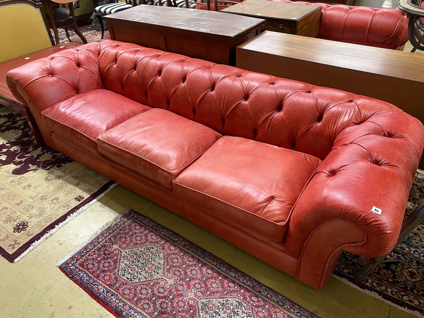 A Victorian style buttoned red leather Chesterfield settee, length 260cm, depth 90cm, height 68cm